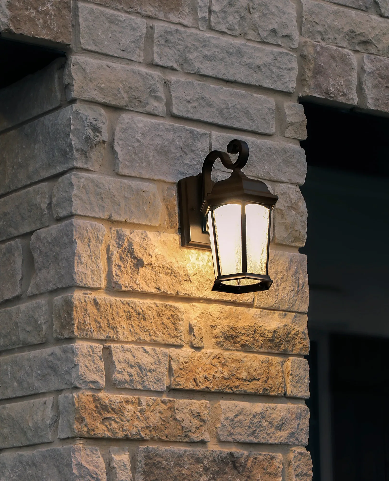 Outdoor Hex Integrated LED Wall Lantern, Dusk to Dawn, 1200 Lumens, 3K Warm White, Wet Location, Black or Bronze Finish with Seedy Glass